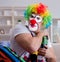 Drunk clown celebrating having a party at home