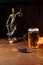 Drunk driving concept. Lady of justice, glass of beer and car key. Vertical image