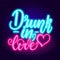 Drunk in love neon. Glowing pink neon incription on dark brick wall background