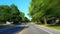 *Drunk Motion Blur Intoxicated Version* Driving Residential City Road With Lush Trees During Summer Day.  Driver Point of View POV