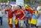 Drunk soccer Spanish fans wearing red T-shirt, faces painted in national colors, cheering for his football team on the street