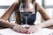 Drunk woman sitting at a table and holding a glass of wine close up. Female alcoholism.