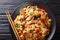 Drunken noodles pad kee mao with chicken, basil, chili pepper and sauce close-up on a plate. horizontal top view