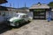 DRVENGRAD, SERBIA - JUNE 15, 2019: Old Police car in front of wooden house of Drvengrad village built by Emir Kusturica