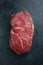 Dry aged raw Wagyu Sirloin Steak offered on a black board