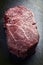 Dry aged raw Wagyu Sirloin Steak offered on a black board