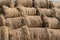 Dry baled hay bales stack, rural countryside straw background. Hay bales straw storage shed full of bales hay on