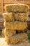 Dry baled hay stack, rural countryside background