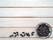 Dry barberries in a bowl on the background of white wooden boards