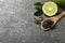 Dry bergamot tea leaves and fresh fruit on grey table, flat lay. Space for text