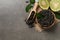 Dry bergamot tea leaves and fresh fruit on grey table, flat lay. Space for text