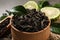 Dry bergamot tea leaves in wooden bowl, closeup