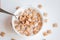 Dry breakfast cereal pads with milk on a white concrete background