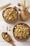 Dry Breakfast of oat flakes, granules and nuts. Muesli in a deep wooden plate.