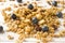 Dry Breakfast of oat flakes, granules and nuts. Muesli on a light table with blueberries