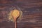 Dry bulgur grain in a wooden spoon.