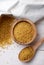 Dry bulgur wheat in bowl and spoon