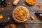 Dry calendula flowers and bottles of essential oil on wooden table, flat lay