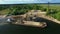 Dry cargo ship bulk carrier crane load crushed stones rock in river dock aerial view fly right