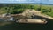 Dry cargo ship bulk carrier crane load crushed stones rock in river dock aerial view fly right