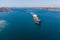 The dry cargo vessel enters the port with the help of tugs. Photo from a helicopter. Bird's-eye view