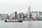 Dry cargo vessel Victoria Harbor in Hong Kong at sunset. View from Kowloon on HK Island