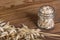 Dry cereal ears detail. Rolled oats in glass jar. Avena sativa