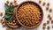 Dry chickpeas in a wooden plate on a white background, isolated.