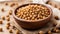 Dry chickpeas in a wooden plate on a white background, isolated.