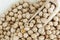 Dry chickpeas with a wooden scoop. Health and natural products. Close-up