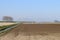 Dry clay fields are sprayed by farmers with water on the island of Goeree Overflakkee in the Netherland