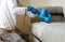 Dry cleaner`s man employee removing dirt from furniture in flat, closeup, vacuum clean sofa with professional equipment