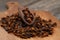 Dry cloves in wooden scoop isolated on wooden background with clipping path. Top view. Flat lay. selective focus