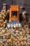 Dry corn kernels on the mini tractor with pile of dry corn kernels on table