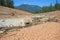 Dry cracked bed of the river during drought, mountain in distance