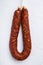 Dry cured  chorizo sausage on white textured background