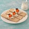 Dry diet crisp breads with cheese, cherry tomatoes and olives