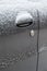 dry dirty and snowy black car door with keyhole of mechanical lock