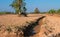 Dry ditch and the ground barren. In agricultural areas.