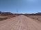 Dry dusty road through the outback, Coober Pedy, red centre of Australia
