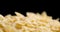 Dry Farfalle pasta slowly rotates.