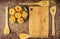 Dry fettuccine paste on a grey ceramic plate next to a bamboo cutting Board and wooden spatulas on a wooden background