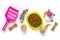 Dry food in bowl, spatula, nail scissors, grass, collar, balls, bones on white background Top view Flat lay Toys, accessories and