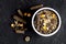 Dry food for rodents in bowl dark background top view