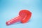 Dry food scoop for pets on blue background.