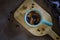 Dry fruits in a cup on a cutting board on a dark background close -up. Walnut, yellow raisins and prunes.