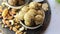 Dry fruits laddu or laddoo is placed in glass bowl on white background.