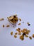 Dry Fruits like Raisin, Kishmish, Cashew and Almond filled in a transparent glass and scattered on isolated white background