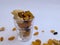 Dry Fruits like Raisin, Kishmish, Cashew and Almond filled in a transparent glass and scattered on isolated white background