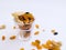 Dry Fruits like Raisin, Kishmish, Cashew and Almond filled in a transparent glass and scattered on isolated white background